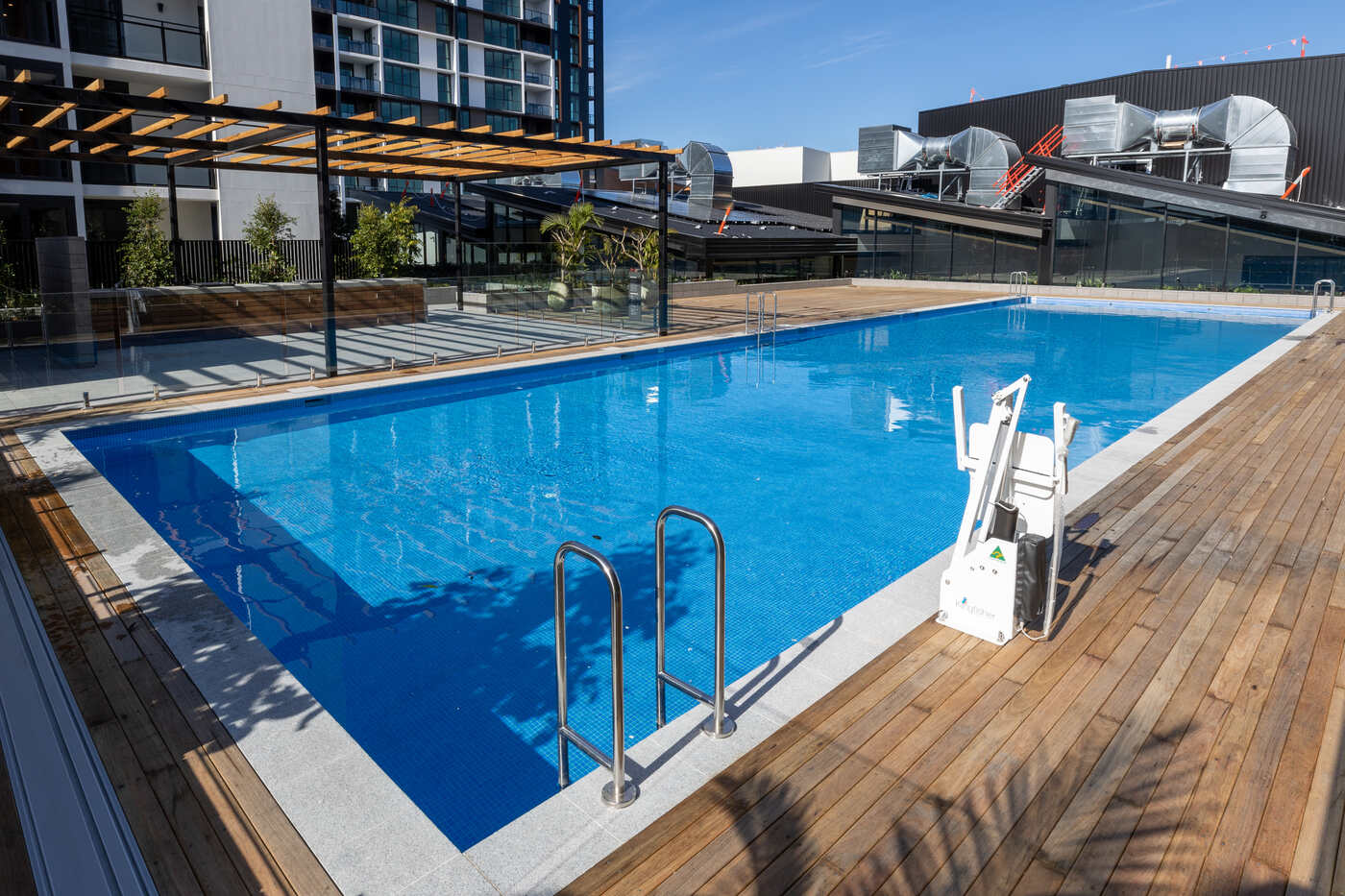 Podium pool, timber deck and apartments, Edmondson Park