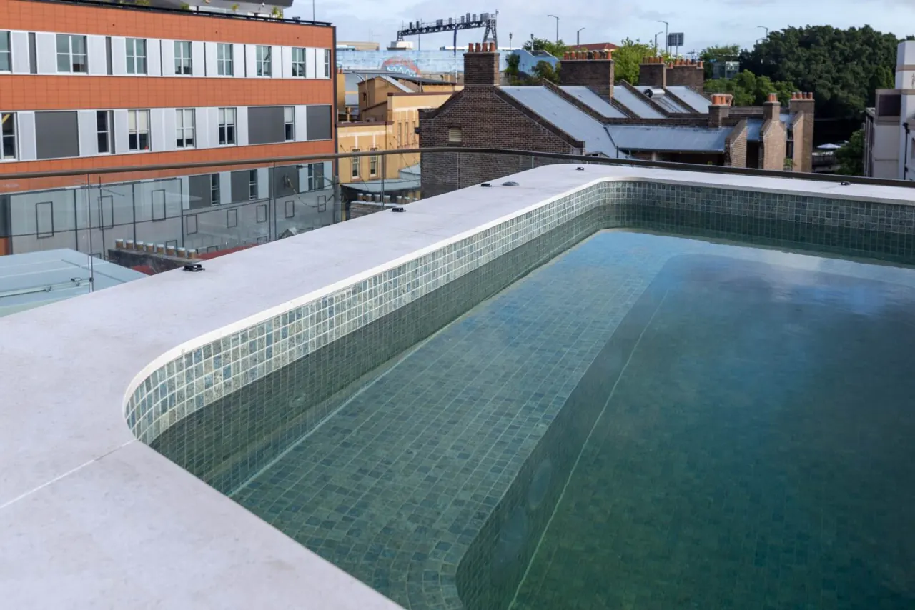 Elevated lap pool in green mosaic running above the rooftops of The Rocks