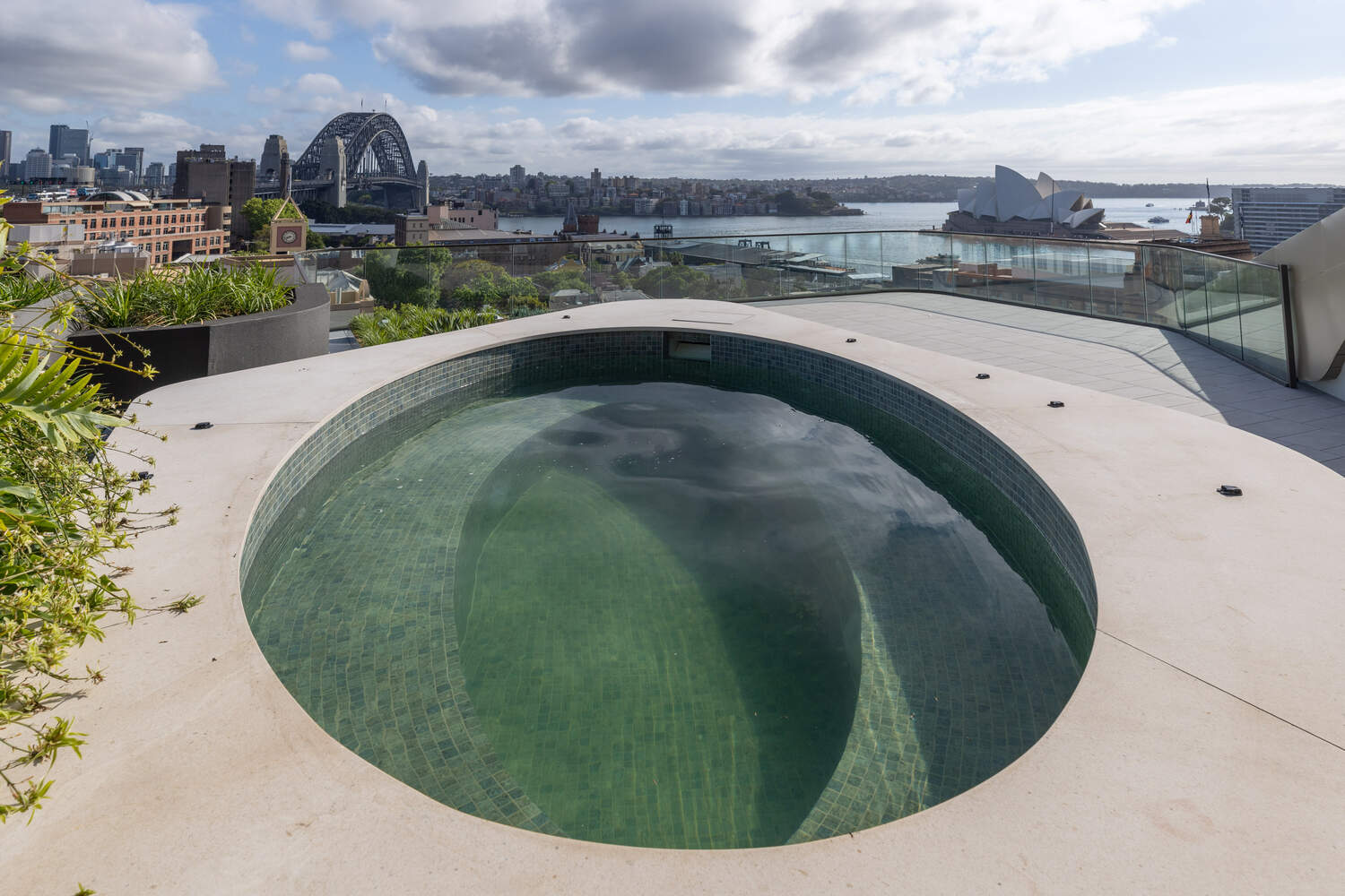 Circular sunken spa in green mosaic with the Harbour Bridge beyond, Harrington Street, The Rocks
