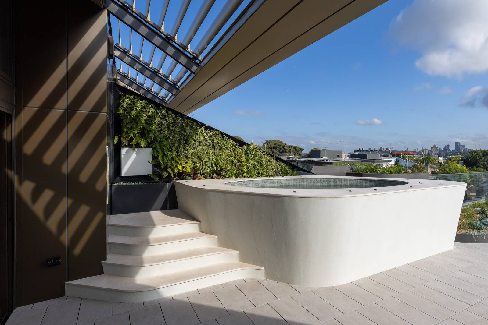 Sculpted white spa and cast concrete steps under the roof canopy, Harrington Street