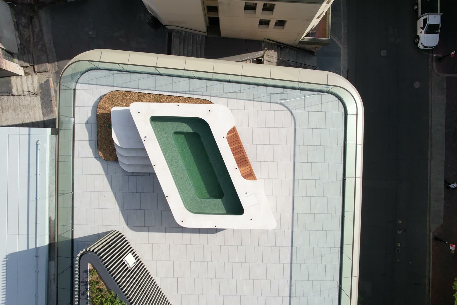 Aerial view of rooftop lap pool with curved cast steps, Harrington Street