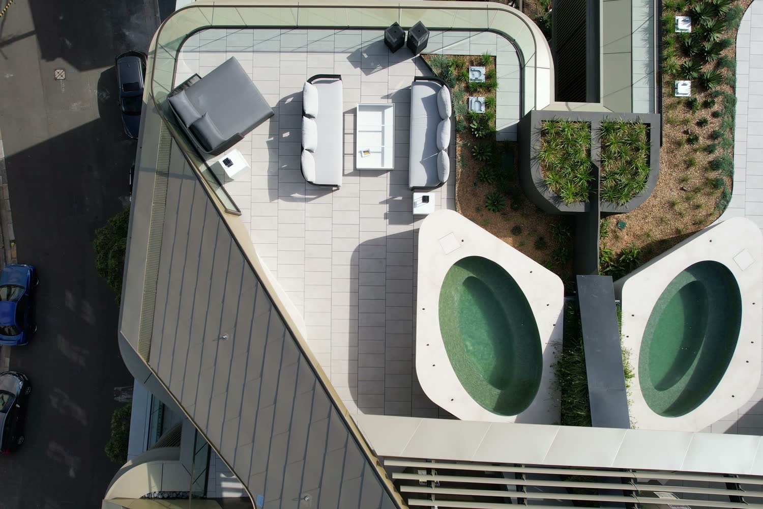 Aerial view of twin oval rooftop spas set into the deck, Harrington Street