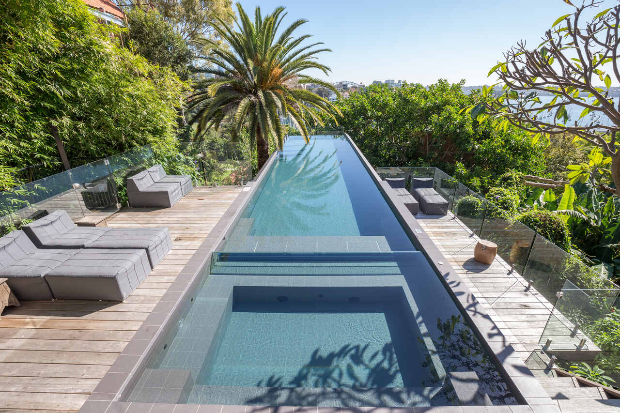 Darling Point pool, sun lounges on the deck with the harbour beyond