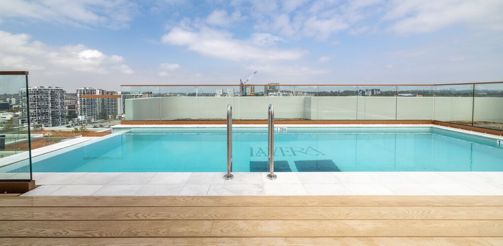 Rooftop lap pool with the La Vera mosaic and the Macquarie Park skyline