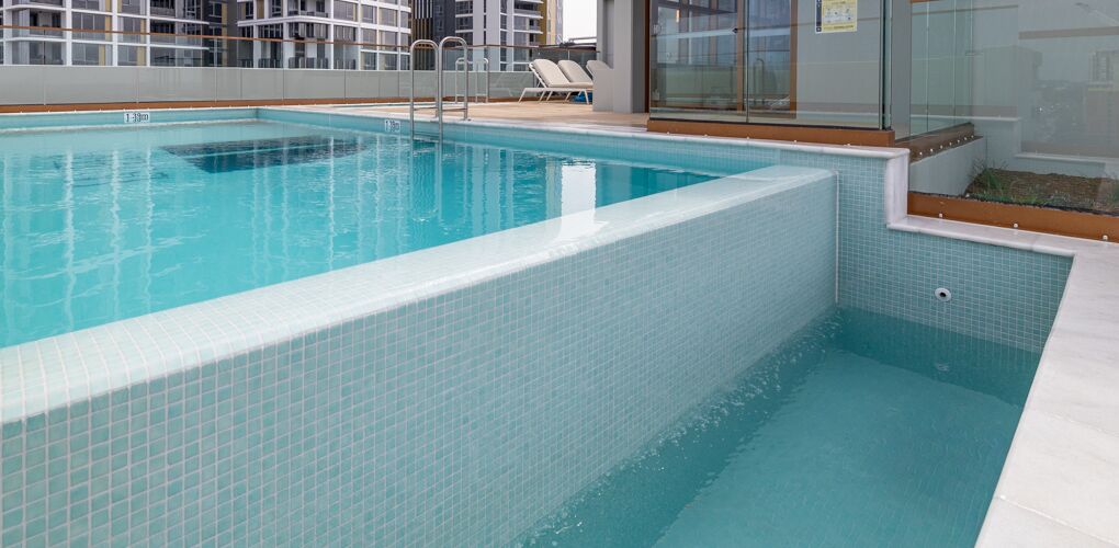 Raised wet edge wall in aqua mosaic tile, La Vera rooftop pool