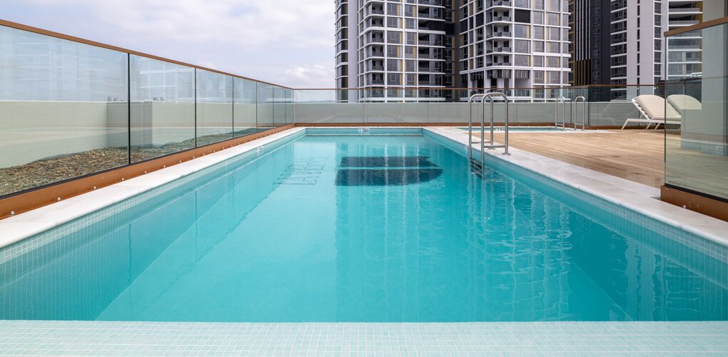 Long view down the lap pool toward the apartment towers, La Vera