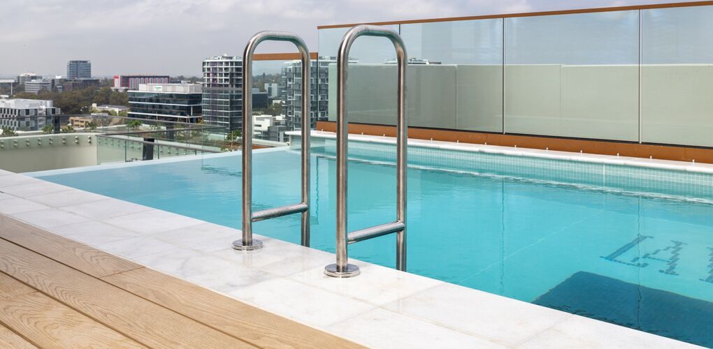 Stainless rails and glass balustrade at the pool entry, La Vera