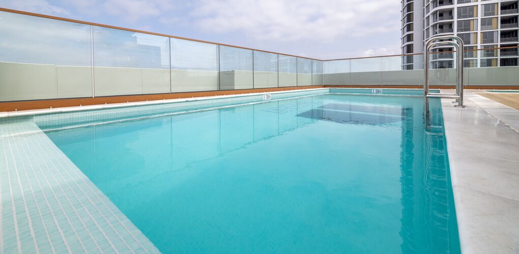 Corner of the fully tiled lap pool with glass balustrade, La Vera