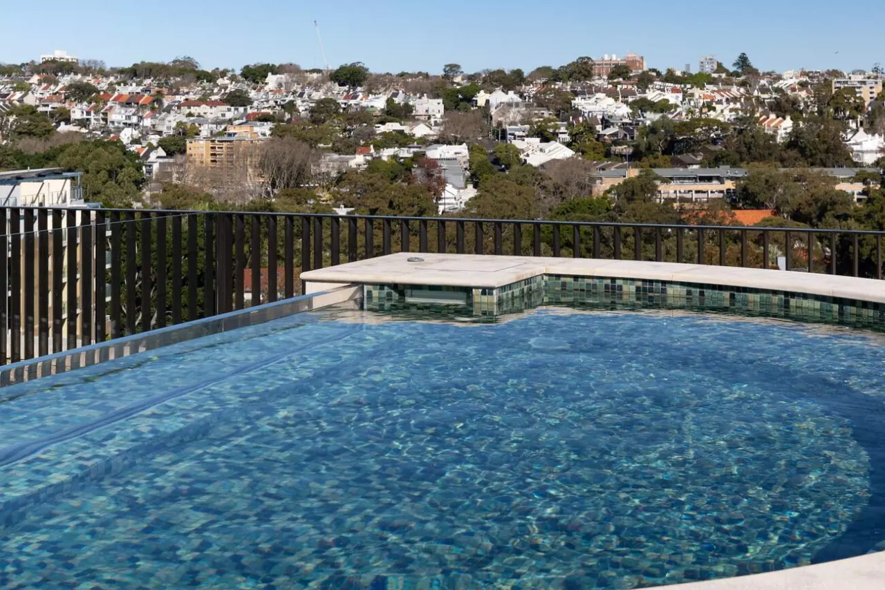 D-shaped rooftop infinity pool at Mona Road, Darling Point, looking over the eastern suburbs