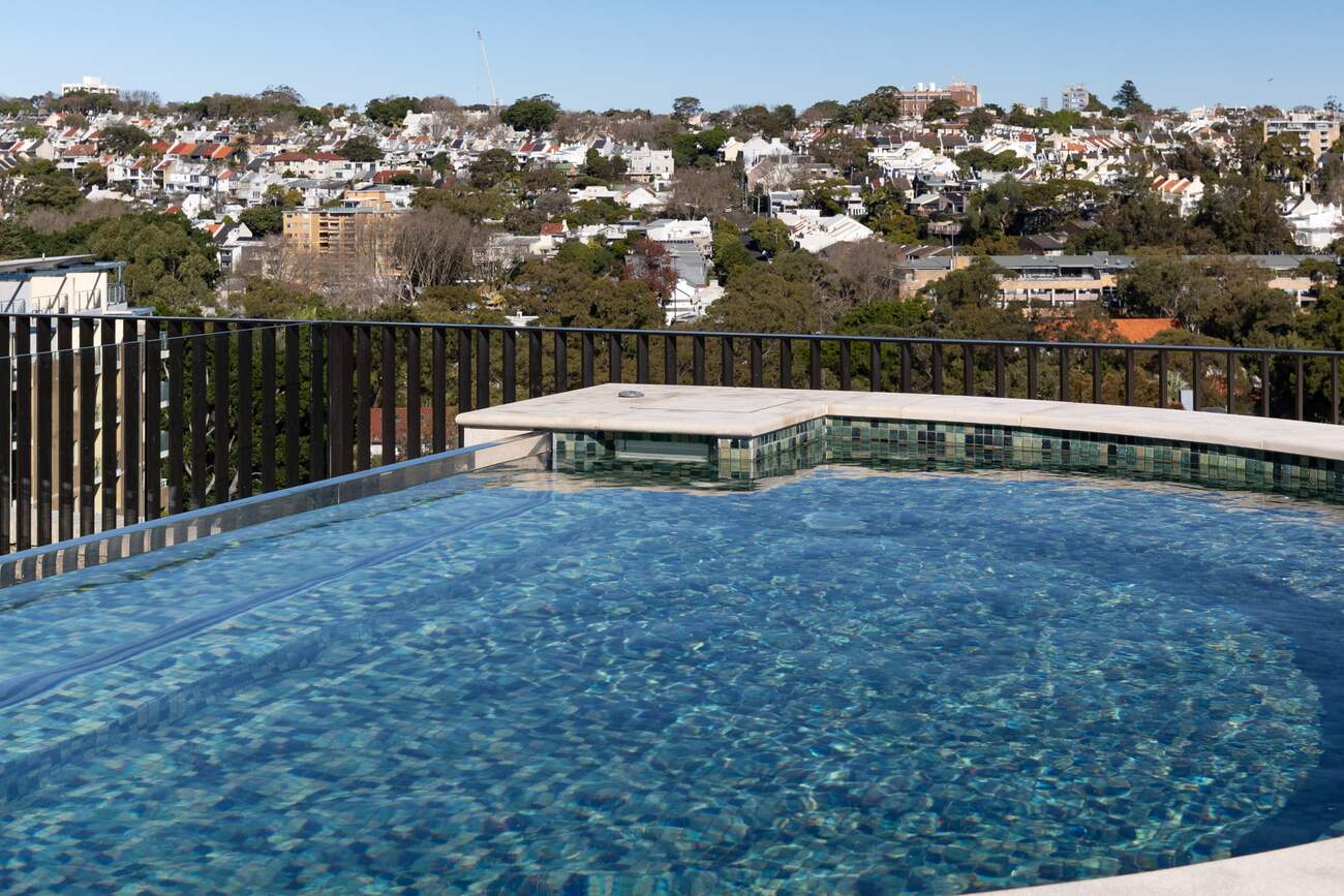 D-shaped rooftop infinity pool at Mona Road, Darling Point, looking over the eastern suburbs