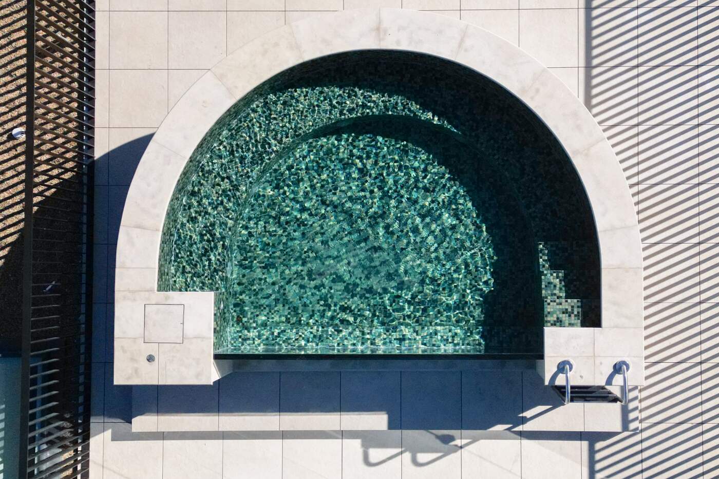 Aerial top-down of the D-shaped mosaic pool at Mona Road, Darling Point