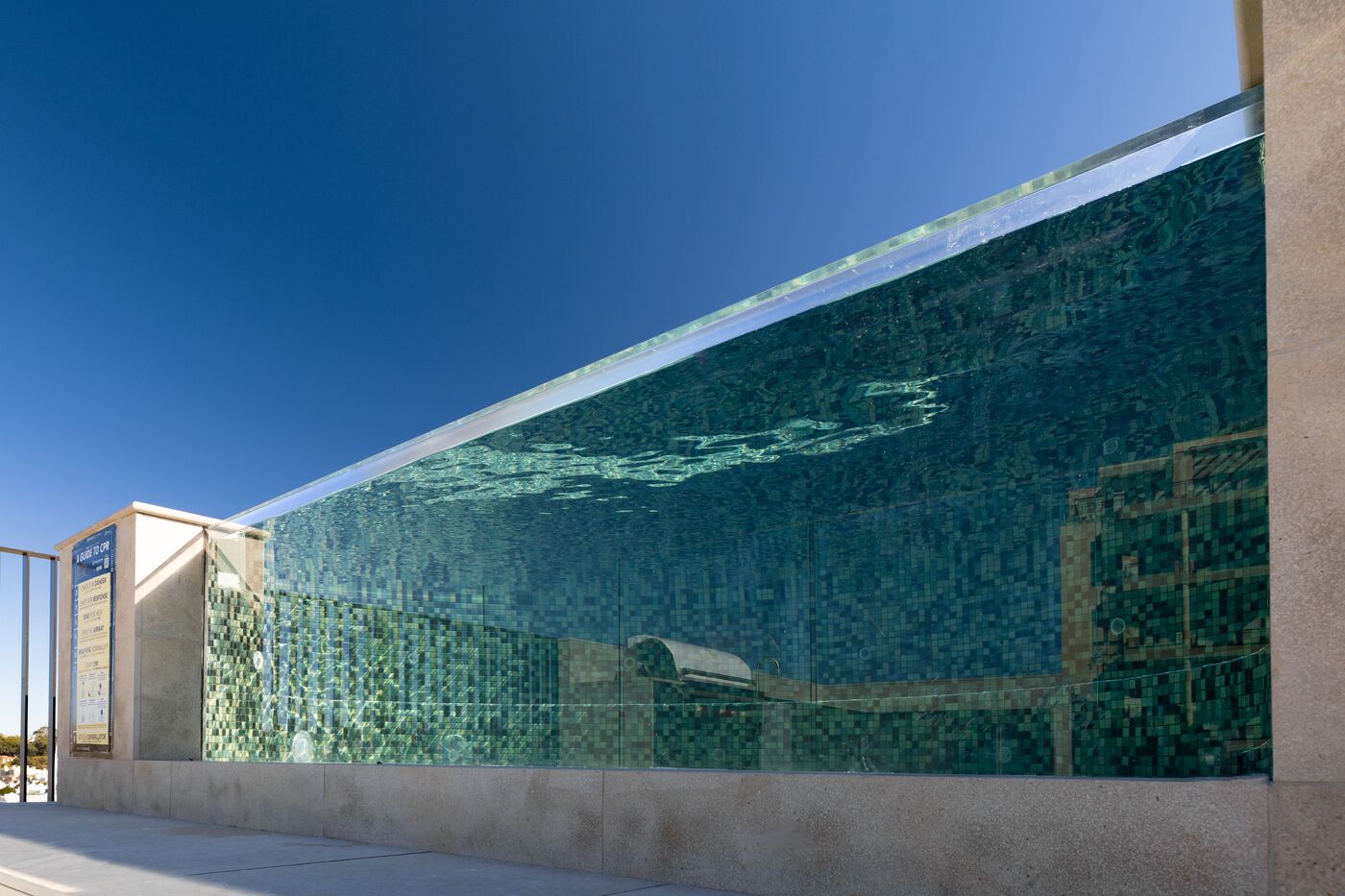 Frameless glass edge and green glass mosaic detail at Mona Road