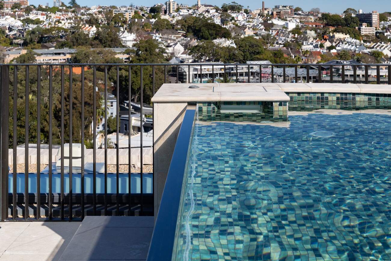 Looking along the rooftop pool over the rooftops of Darling Point