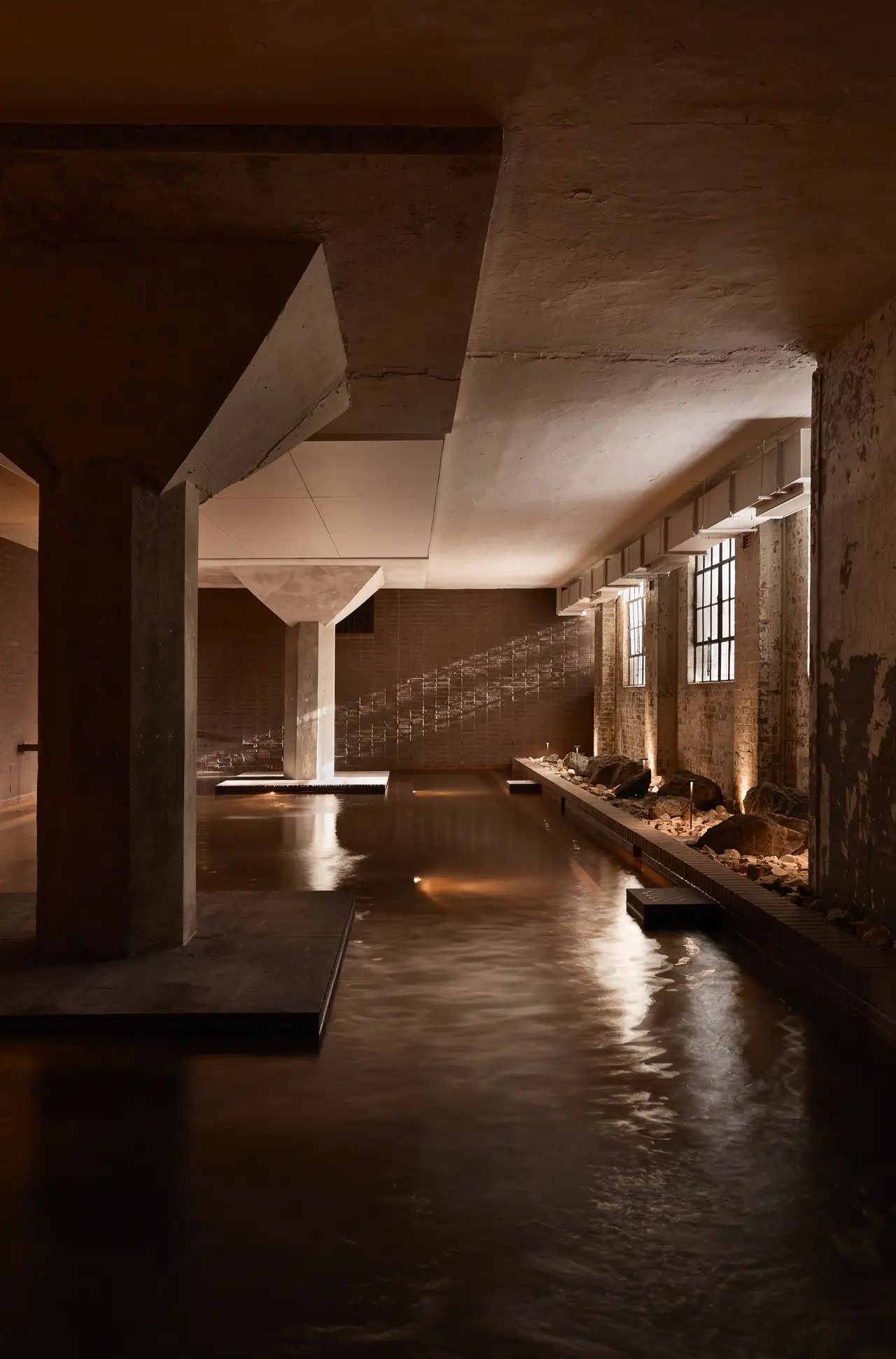 Hot mineral pool running between the original warehouse columns, Sense of Self
