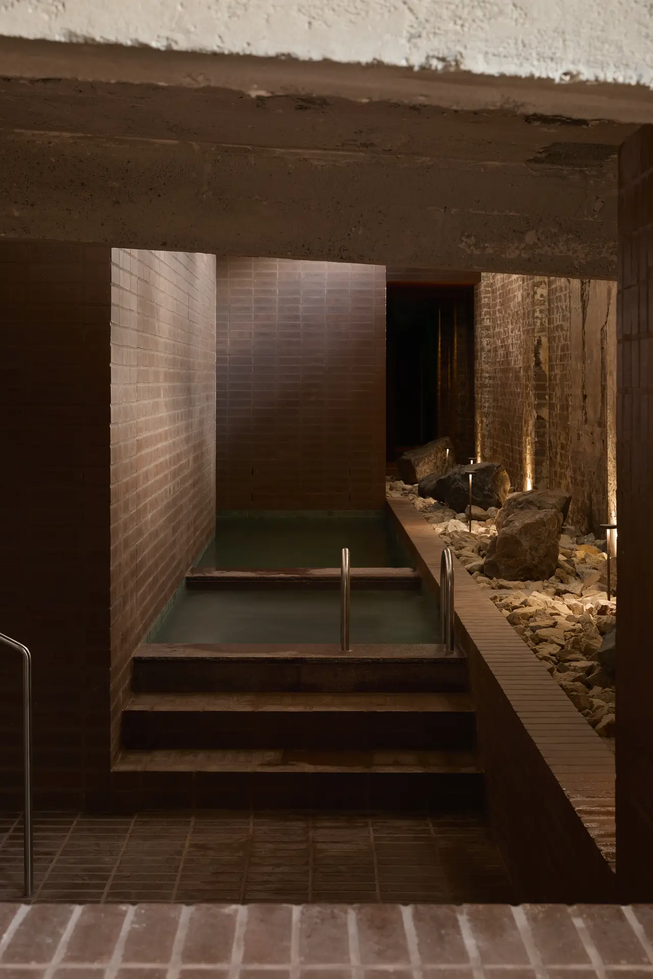 Tiled steps into the cold plunge and hot pool, Sense of Self bathhouse