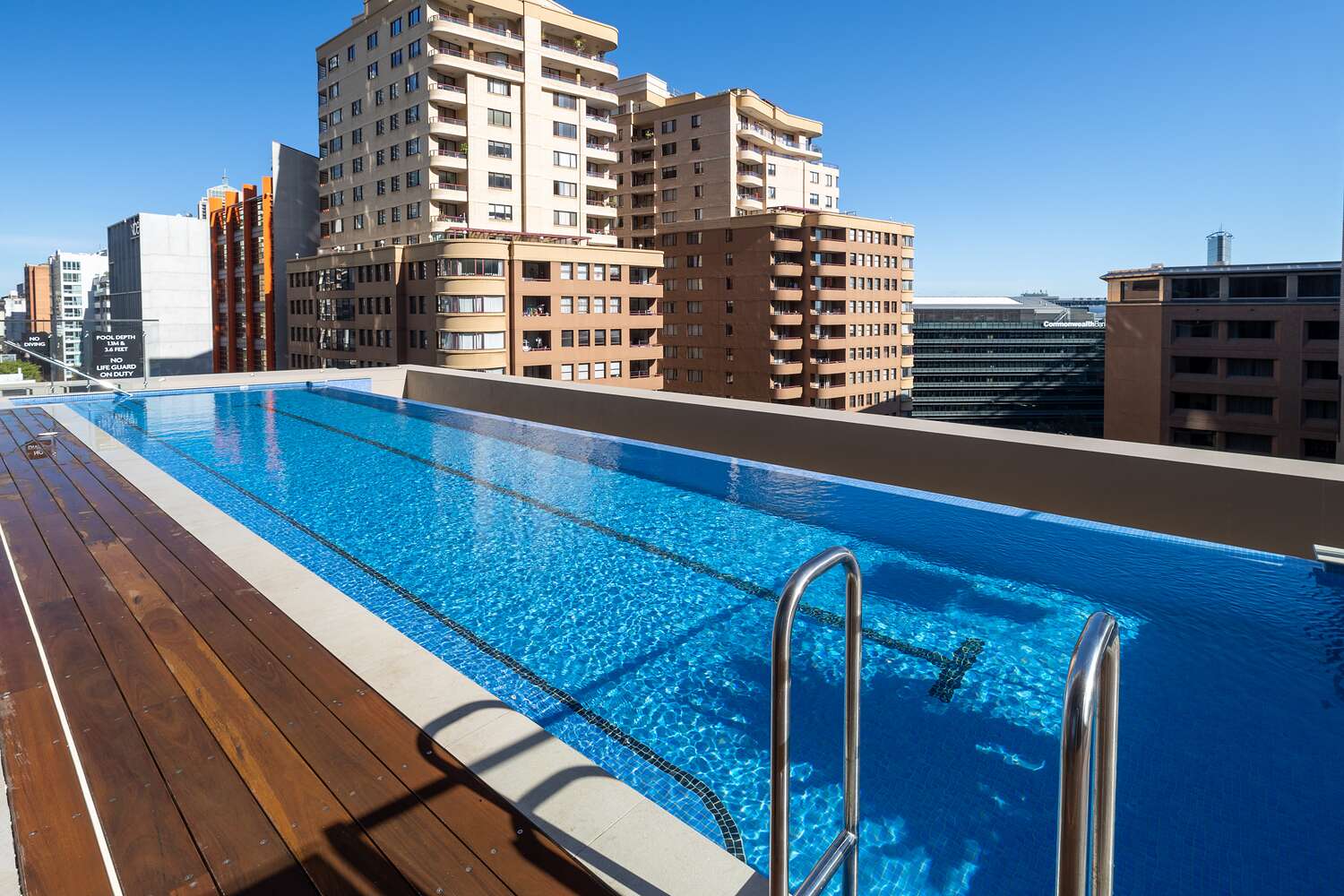 High-rise communal pool with timber deck and city, Sussex Street