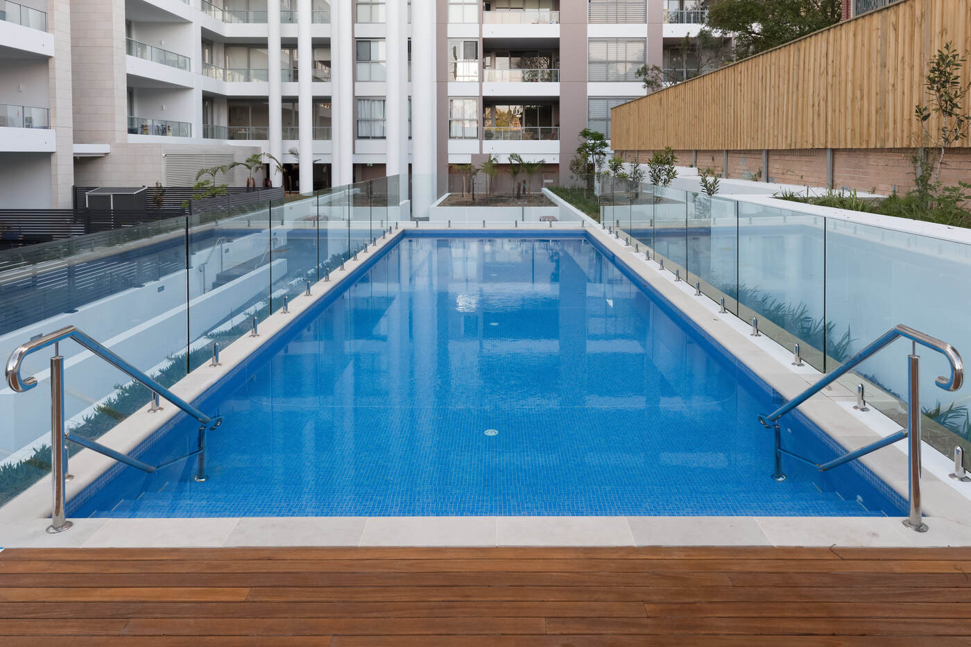 Blue mosaic lap pool with rails, The Carl