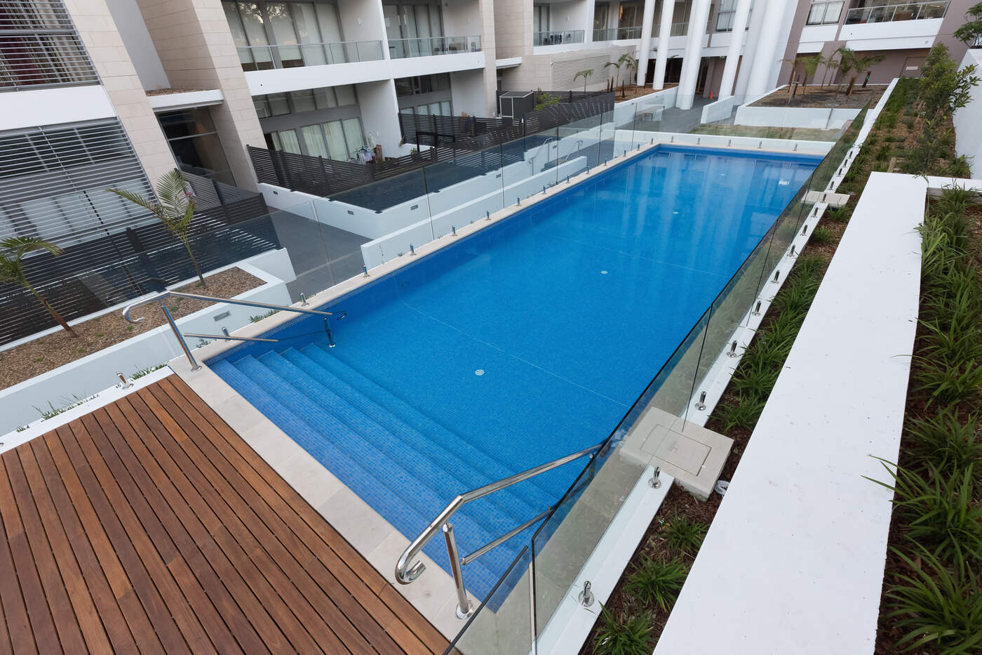 Raised pool with glass balustrade and planting, The Carl