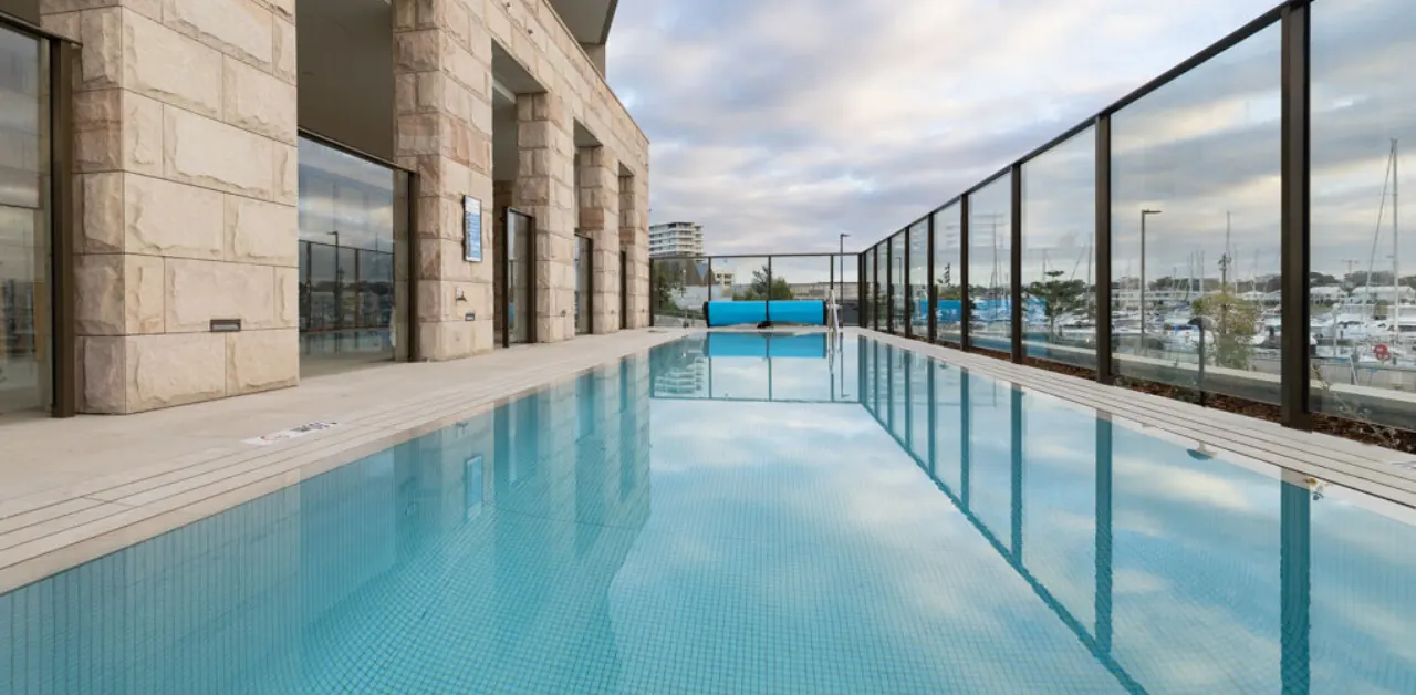 Fully tiled lap pool with glass balustrade, Vela Apartments
