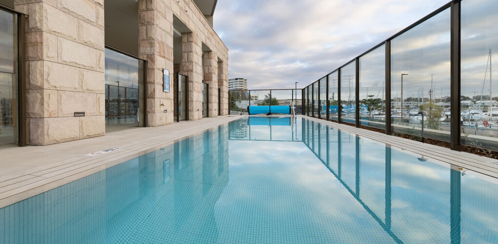Fully tiled lap pool with glass balustrade, Vela Apartments