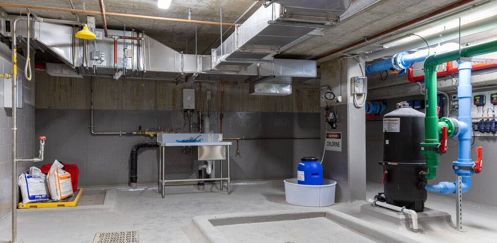 Commercial plant room with ductwork and pipework, Vela Apartments