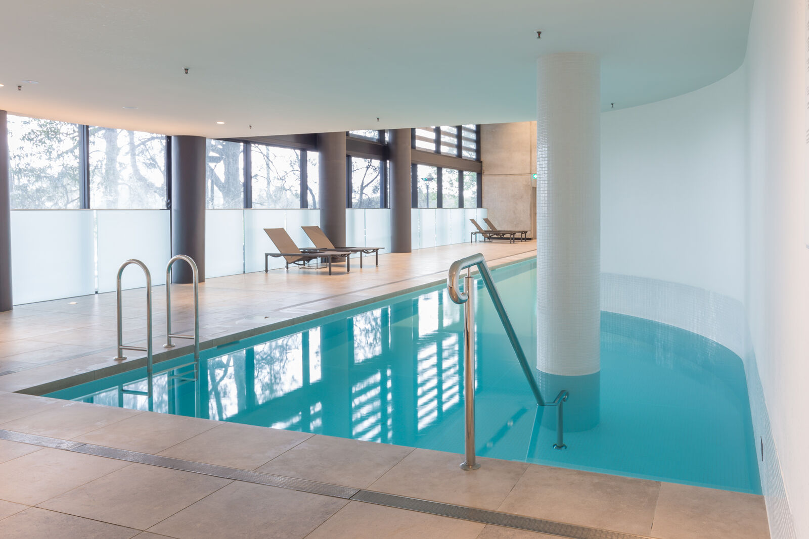 Indoor communal pool with sun lounges and full height glazing, Woolooware Bay Stage 1
