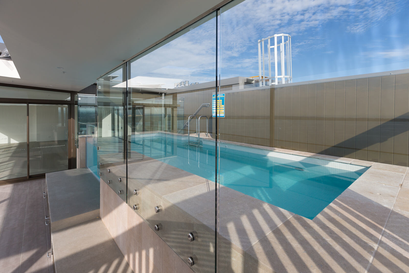 Rooftop pool with frameless glass edge and bay outlook, Woolooware Bay Stage 2